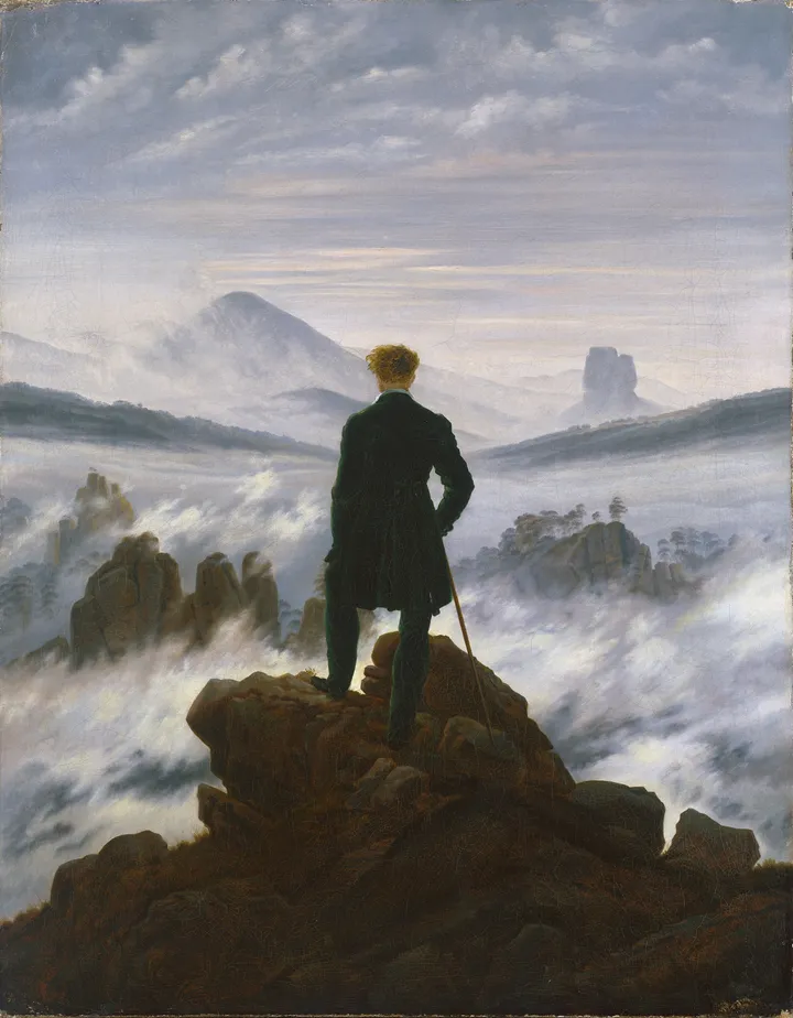 Wanderer above the Sea of Fog, a painting by Caspar David Friedrich: a man seen from behind stands on a rocky peak looking out over mountains in mist.
